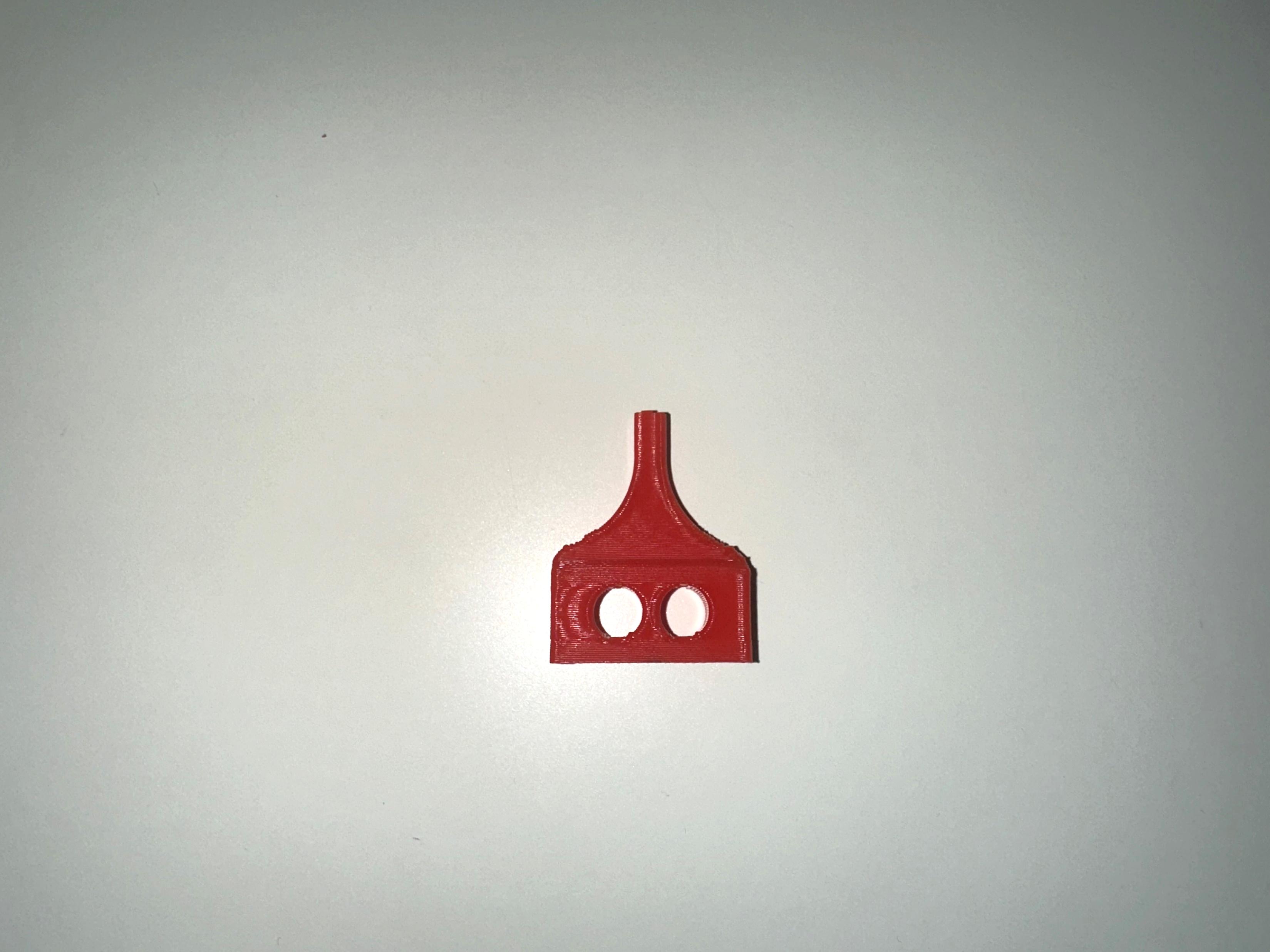 3D printed dog-bone tab connector piece — mounting interface for breaker bridge